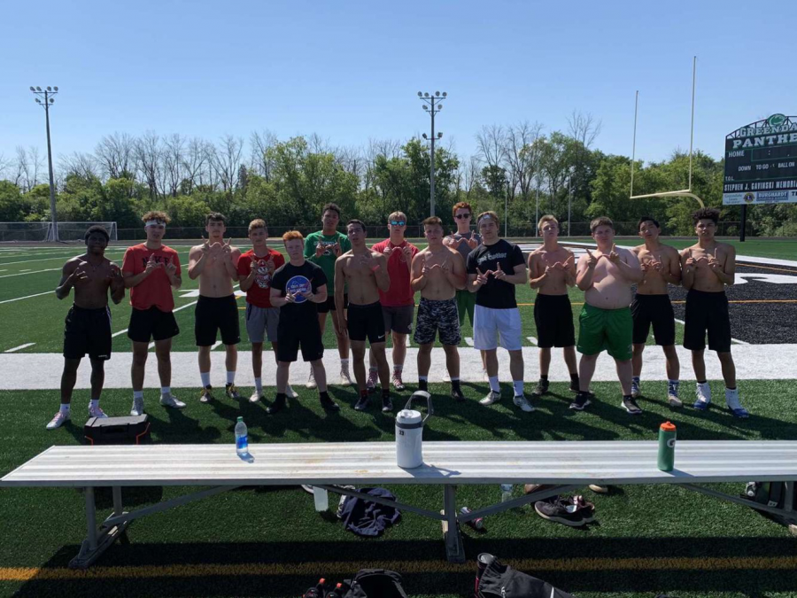 The football team holds up W’s after putting in hard work at Hump Day Hundreds.