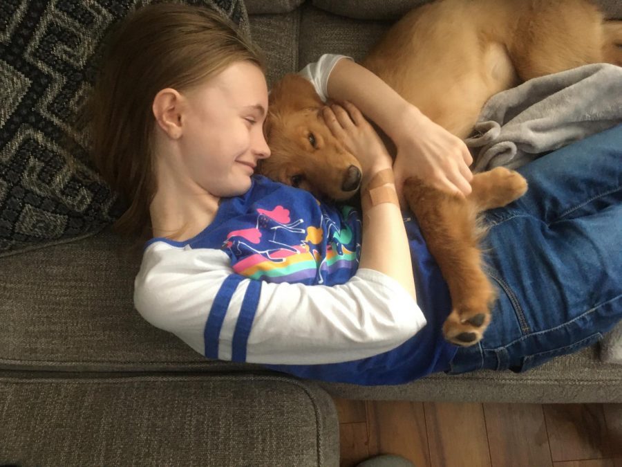 Kylie+Merkel+cuddles+with+her+dog+Murphy.