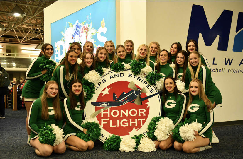 Cheerleaders greet the Veterans off of the Stars and Stripes Honors flight