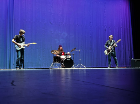 Giovani Adamavich, Bram Van Roo, and Ben Fons perform Purple Haze at the talent show.