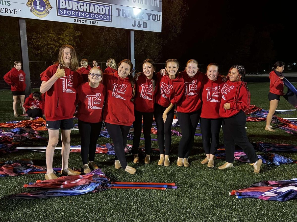 Group of freshman pose for a photo before the bands halftime performance